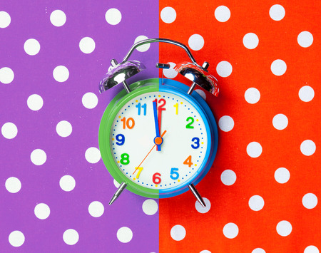 photo of cool alarm clock on the wonderful colorful background in pop art style
