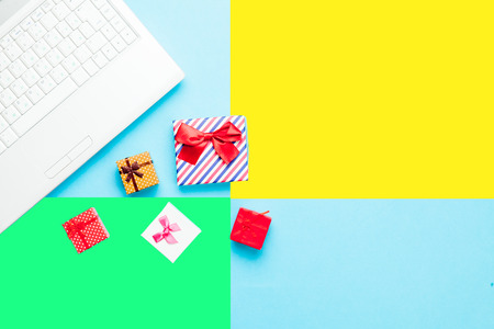 cute gifts and silver laptop on the wonderful colorful  background in pop art styleの写真素材