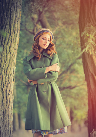 photo of beautiful young woman on the wonderful trees backgroundの写真素材