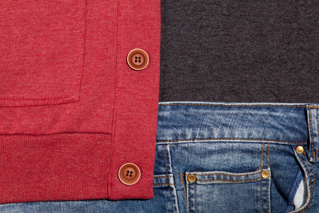 photo of cool fashionable look of jeans, shirt and cardigan in close-up