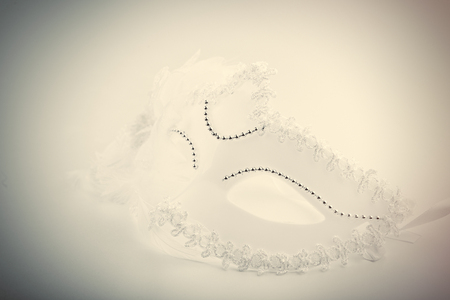 photo of beautiful masquerade mask on the wonderful white studio backgroundの写真素材
