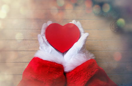 Santa Claus have wrapping a Christmas box on wooden backgroundの写真素材