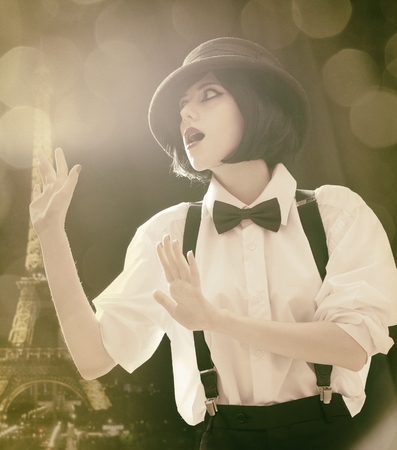 Fashion women with bow tie with Parisian Eiffel Tower on background