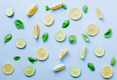 Above view at cutted lemons and limes on grey backgroundの写真素材