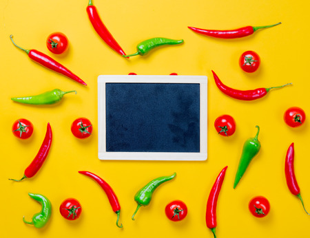 Above view at Chili pepper and blackboard on yellow backgroundの写真素材