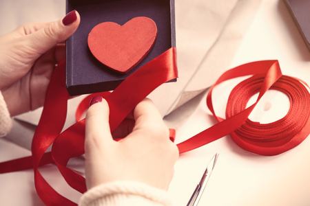 Woman preparing gift for wrapping for Valentine's Dayの写真素材