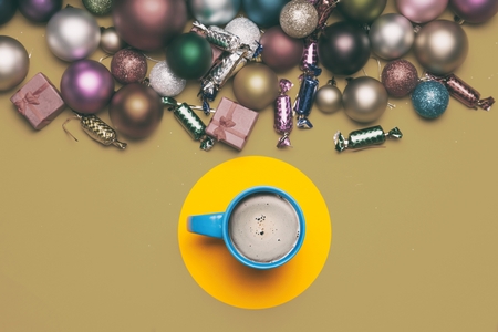 Cup of coffee and christmas gifts on yellow background.の写真素材
