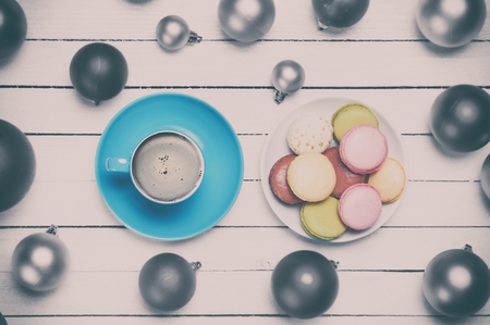 Cup of coffee and macaron with christmas toys on whte background.の写真素材