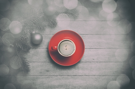 Cappuccino and  pine branch on wooden table.の写真素材