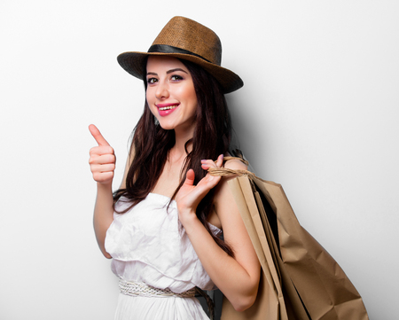 portrait of the beautiful young woman with shopping bagsの写真素材