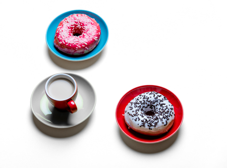 photo of the glazed donuts on the plates and cup of coffeeの写真素材