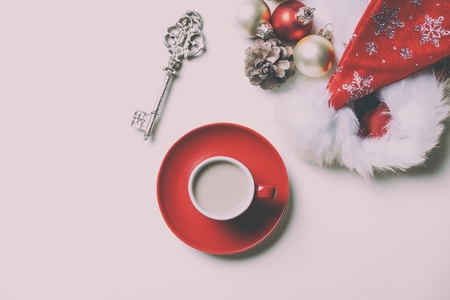 photo of the beautiful Christmas decorations, red cup of coffee and golden keyの写真素材