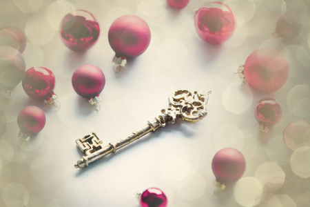 Red christmas baubles and golden key on white backgroundの写真素材