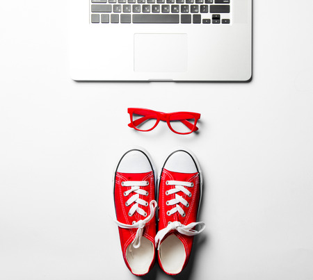red glasses, gumshoes and laptopの写真素材