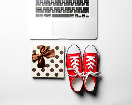 gift, red gumshoes and laptopの写真素材
