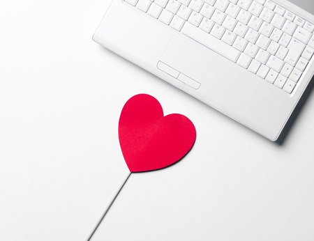 heart shaped toy and laptopの写真素材