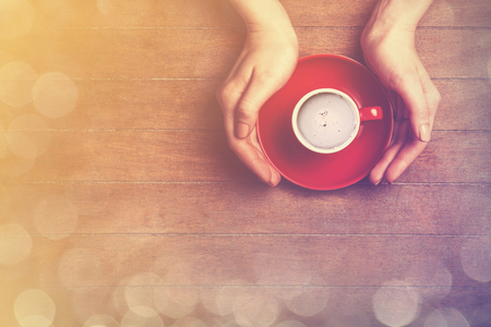 Female hands holding cup of coffee.の写真素材
