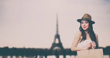 Young woman with shopping bags at Parisian backgroundの写真素材