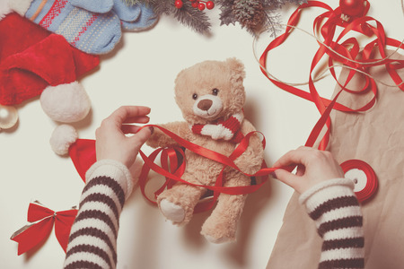 Woman have wrapping a teddy bear toy. High point of viewの写真素材
