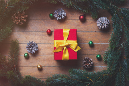 Christmas gift boxes and pine branch on wooden table. Hight angle point of viewの写真素材