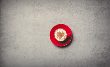 Red cup of coffee on grey background, view aboveの写真素材