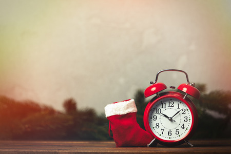 Christmas gift with bowknot and Santa Claus sock on grey backgroundの写真素材