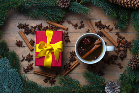 Cup of tea with star anise and cinnamon around Christmas decorationの写真素材