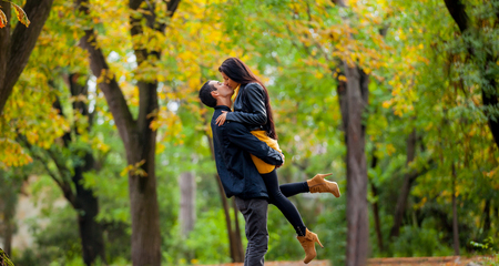 Young couple in love kissing at autumn season outdoorの写真素材