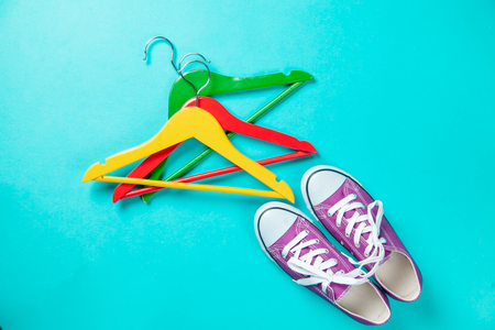 Hanger and gumshoes on blue backgroundの写真素材