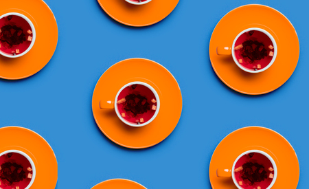 Orange cups of tea on blue background. Above view の写真素材