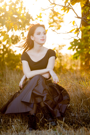 Hipster redhad girl in skirt at autumn time sunset outdoorの写真素材