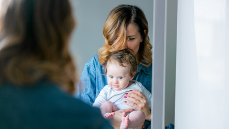 Redhead mother and son play together at homeの写真素材