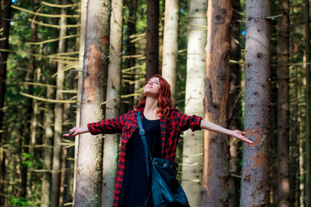 Redhead girl in green summer Carpathian forestの写真素材