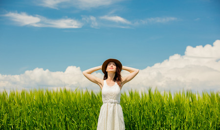 Beautfiul girl in dress at wheat field in summertime seasonの写真素材