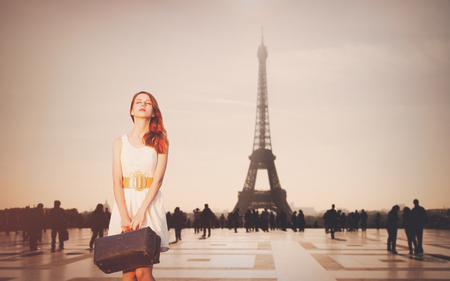 Beautiful redhead woman from province has come to conquer Paris. Eiffel tower on backgroundの写真素材