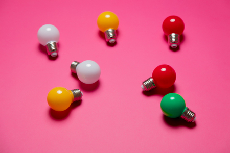 Group of colored lightbulbs on pink bakgroundの写真素材