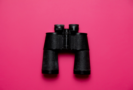 Vintage black binoculars on pink background, High angle viewの写真素材