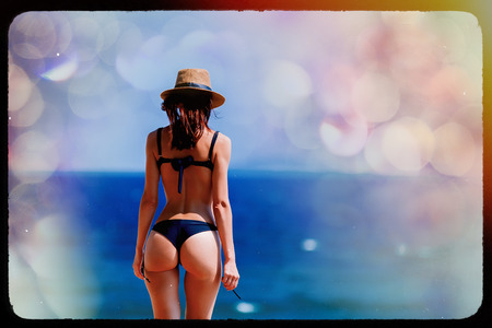 Young beautiful girl in bikini on the beach in Greece. Summertime vacation conceptの写真素材