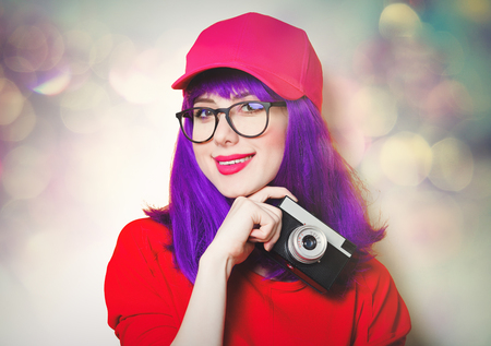 portrait of beautiful smiling young woman with retro cameraの写真素材