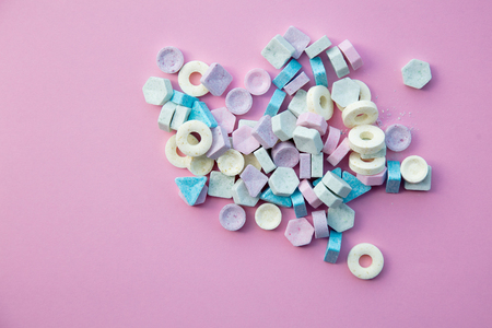 Colorful candies isolated on pink background. Natural light, above viewの写真素材