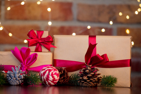 gift boxes on background with fairy lights in bokeh. Christmas Holiday season