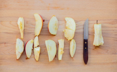 Cut natural apple and knife on wooden table. Above viewの写真素材