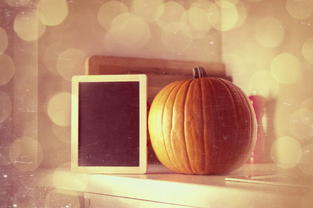 Beautiful Autumn pumpkin and blackboard menu on a table in kitchenの写真素材
