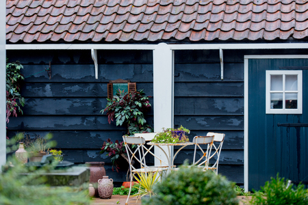 Little garden and table with chairs near wooden house in Holland. Netherlandsの写真素材