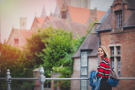 young girl in red sweater at streets of Bruges. Belgium, Atumn seasonの写真素材