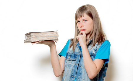 Portrait of young teenage girl with books on white backgroundの写真素材