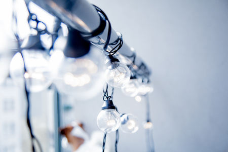 Closeup view at fairy light lamps on grey backgroundの写真素材