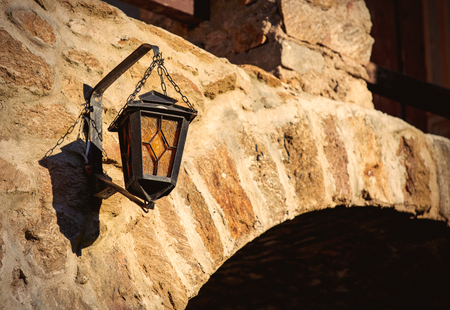 View on old lamp on castle brick wall. Closeup viewの写真素材