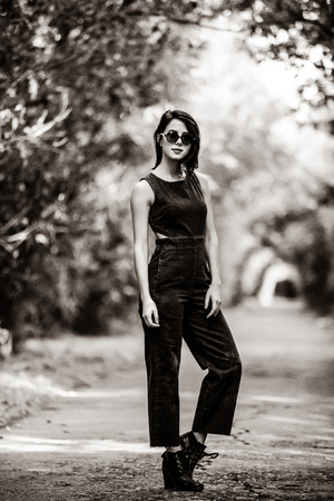 portrait of the beautiful young woman standing in the middle of the roadの写真素材