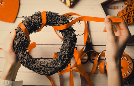 Female hands wrapping wreath to present to someoneの写真素材